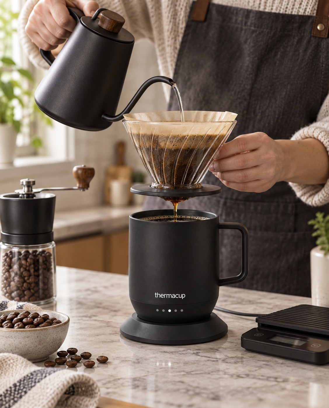 A coffee enthusiast brewing pour-over coffee into a black Thermacup