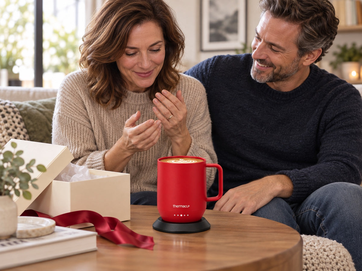 An adult receiving a red Thermacup as a gift from their partner