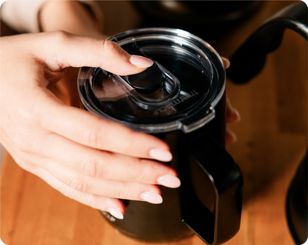A close-up of the Thermacup sliding lid in use